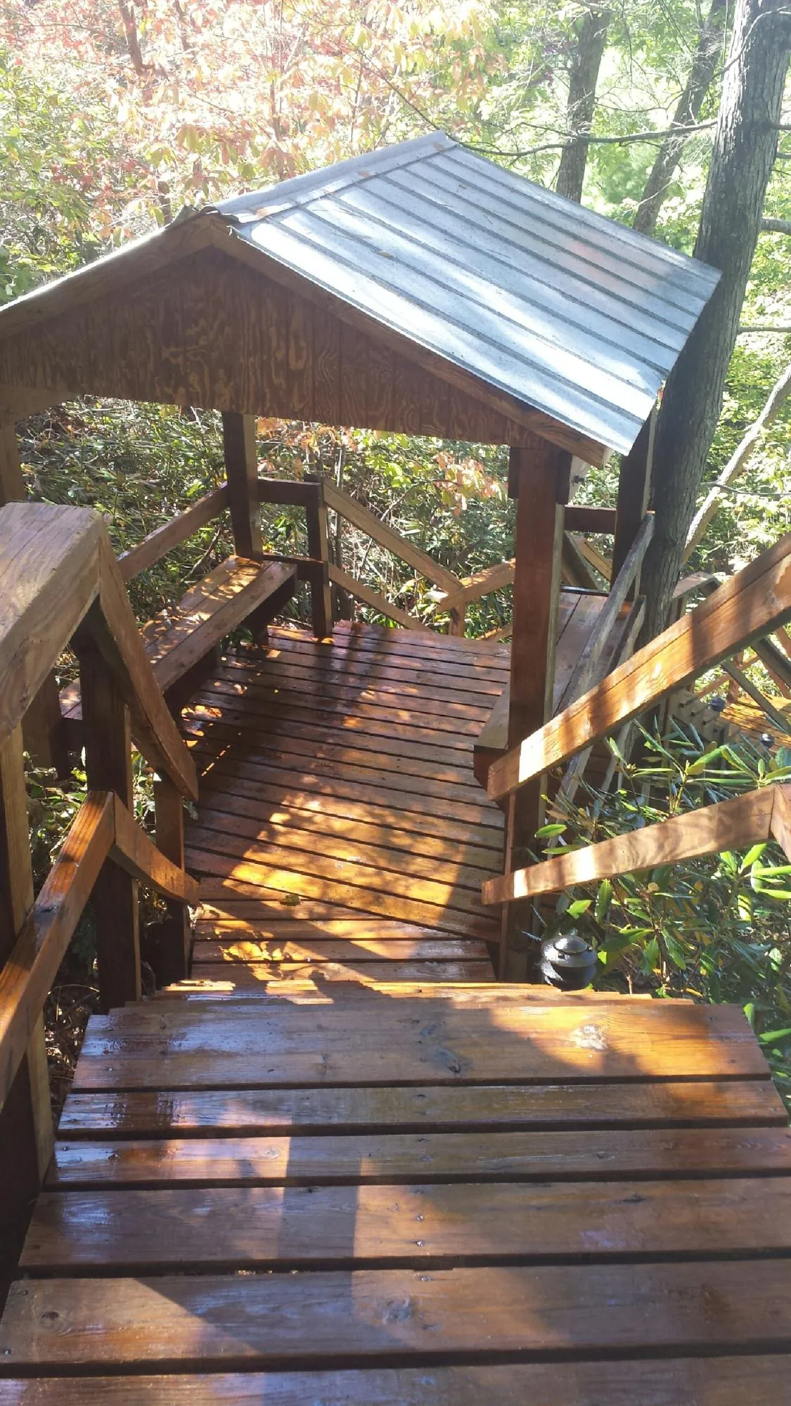 Freshly stained wood walkway and covered shelter with a metal roof in Camp Verde
